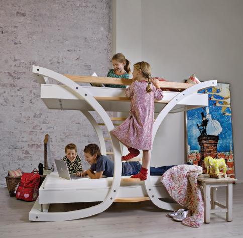 Wooden bunk beds spread with colorful quilts and blankets for the 